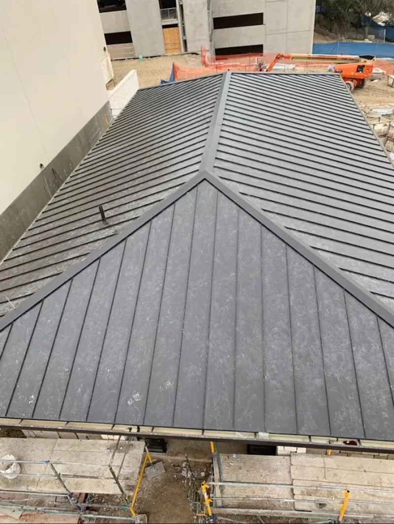 Commercial metal roof construction with crane equipment in Richland Hills