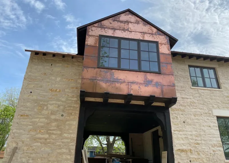 Copper metal panel facade on a stone building for Roof Repair in Richland Hills